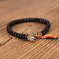 Bracelet Tibétain Bouddhiste en perle de Noix de Coco taillées et gravées.