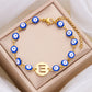 Women's High-grade Stainless Steel Blue Eyes Fashion Hollowed-out 26 Letter Bracelet